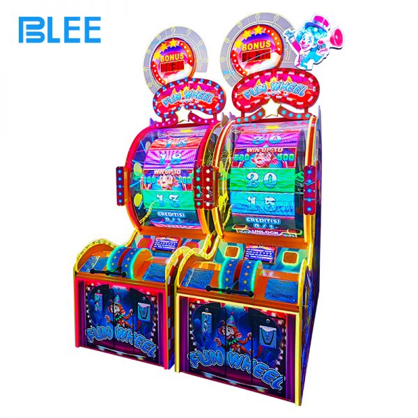 players spinning fun wheel game to win tickets in amusement park