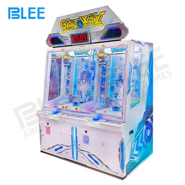 players playing coin operated ball pusher arcade machine in FEC