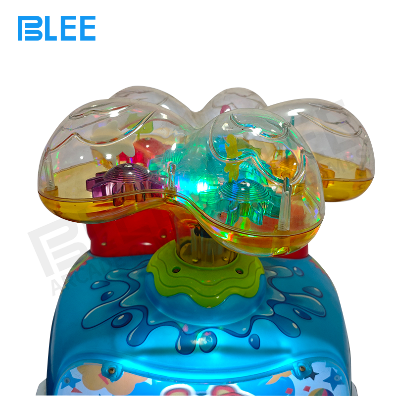 Parent taking photos of child on blue whale swing ride