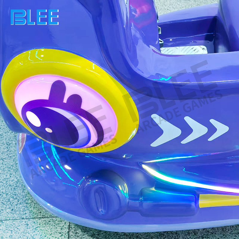 Vibrant LED lights on blue BLEE kids swing ride at night