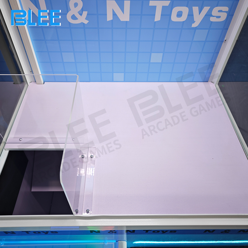 Interior showcase of claw mechanism operating within wooden crate enclosure