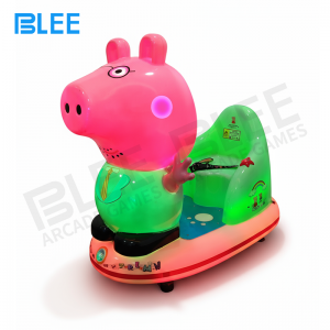 Children enjoying pig themed electric swing ride
