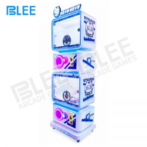 Happy customer holding obtained capsule prize from the machine