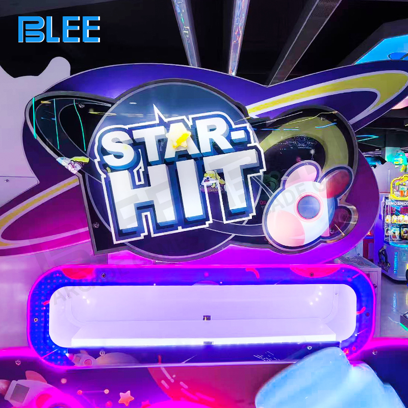 Child receiving prize card from machine with excited expression after successful gameplay session