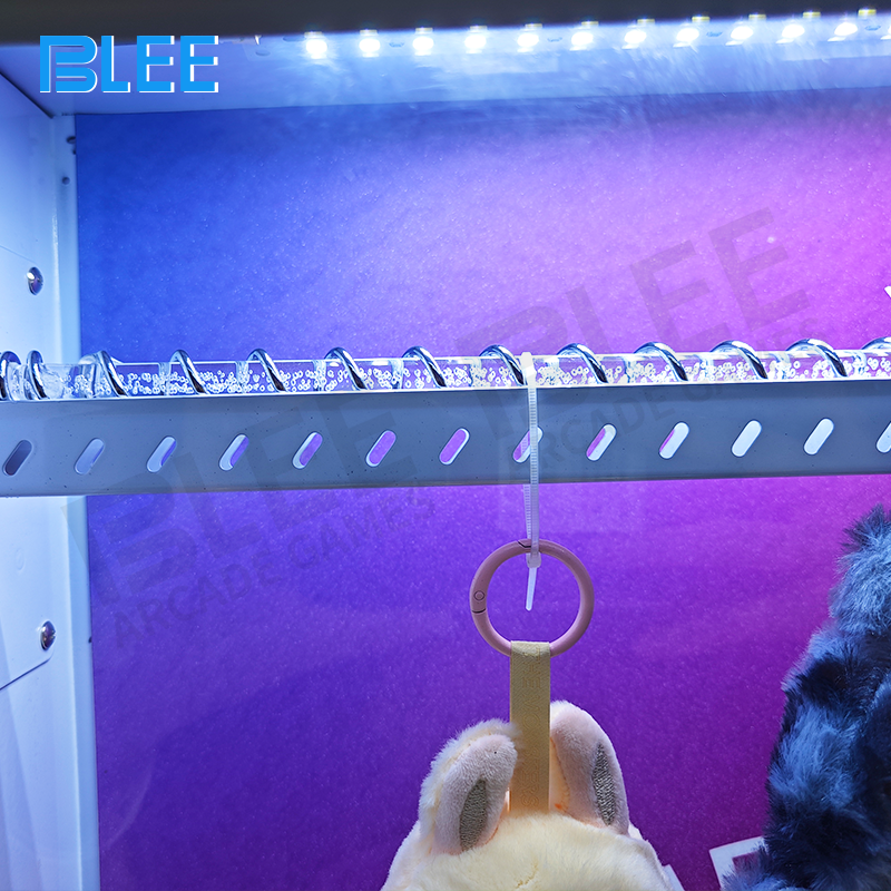 The prize dispensing unit activating to deliver a reward after a high-score round.