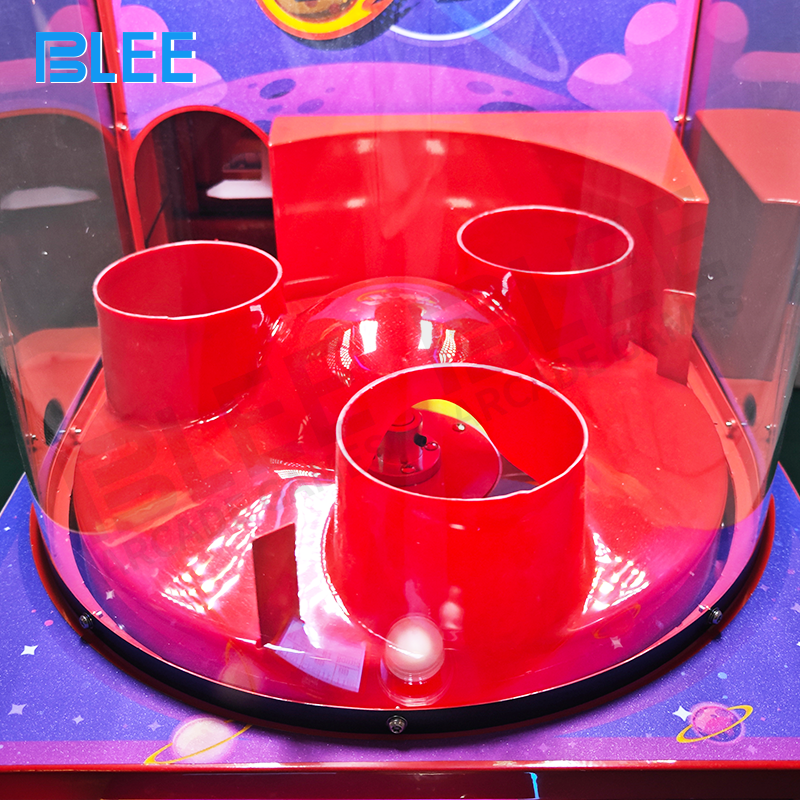 Close-up of colorful balls navigating through transparent maze sections of the tower