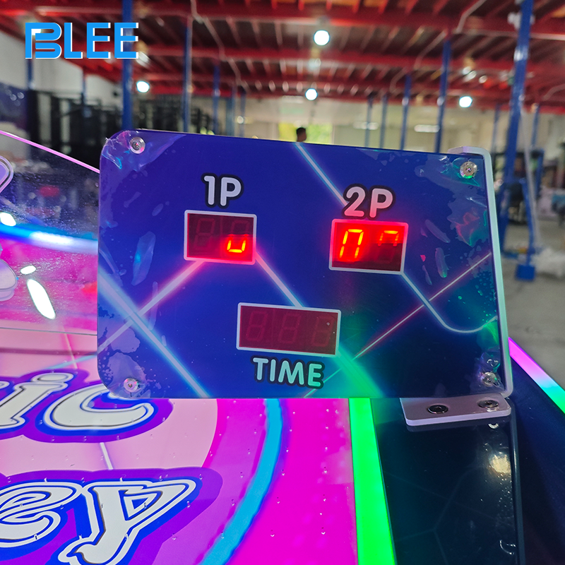 Dynamic action shot capturing a goal scored as the puck disappears into the goal slot.