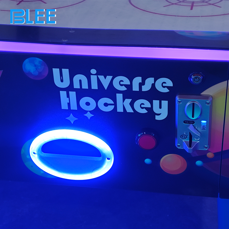 Dynamic action shot capturing a goal scored as the puck enters the illuminated goal slot.