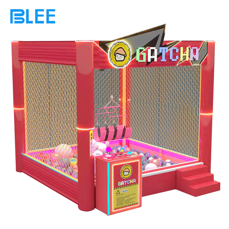 coin-operated interactive game BLEE Human Crane Experience with spacious transparent prize pit featured in a bustling family entertainment center.