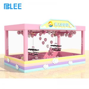 Excited winner emerging from the prize pit holding multiple stuffed animals after a successful session.