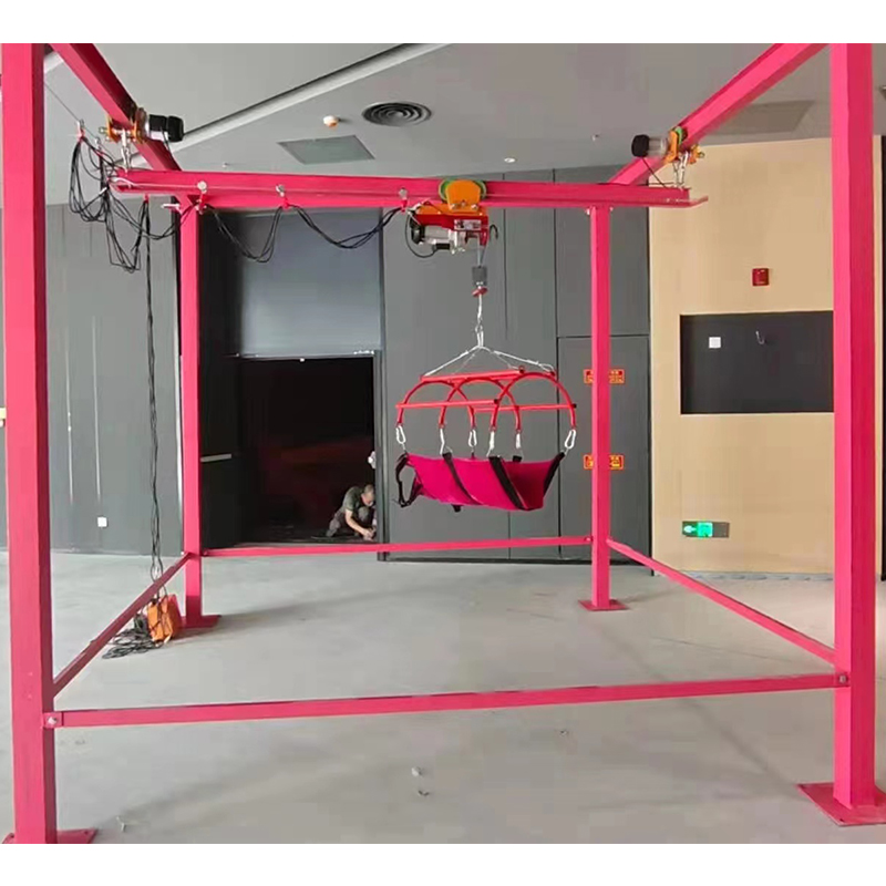 Close-up of the fail-safe lifting mechanism with emergency stop button and secure harness attachment.