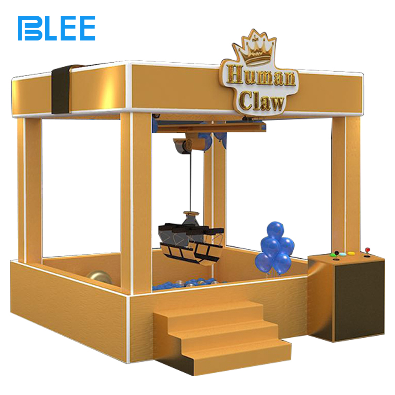 real-life claw machine Full front view showcasing the walk-in design, overhead harness system, and spectator viewing panels.